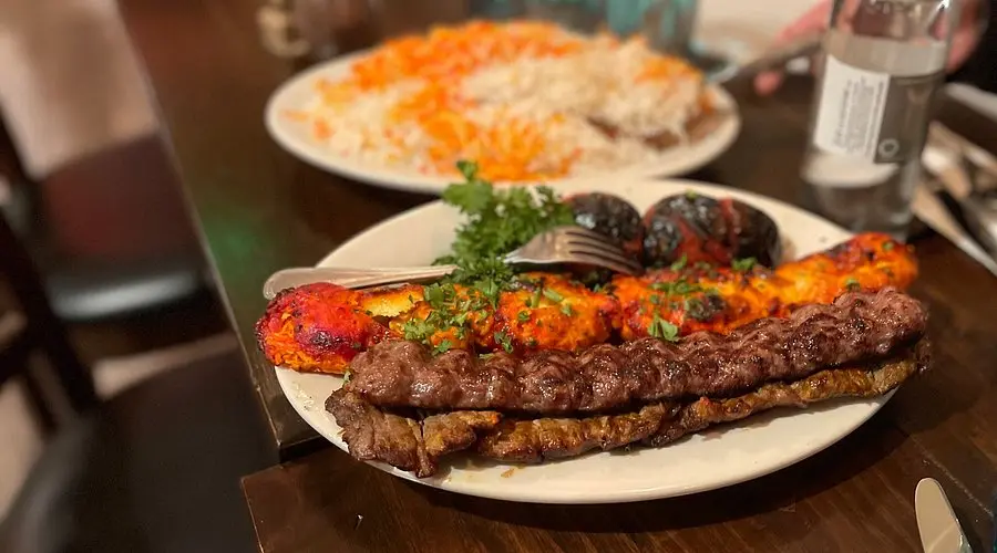 Mixed chicken and beef kabobs prepared by Aria Palace